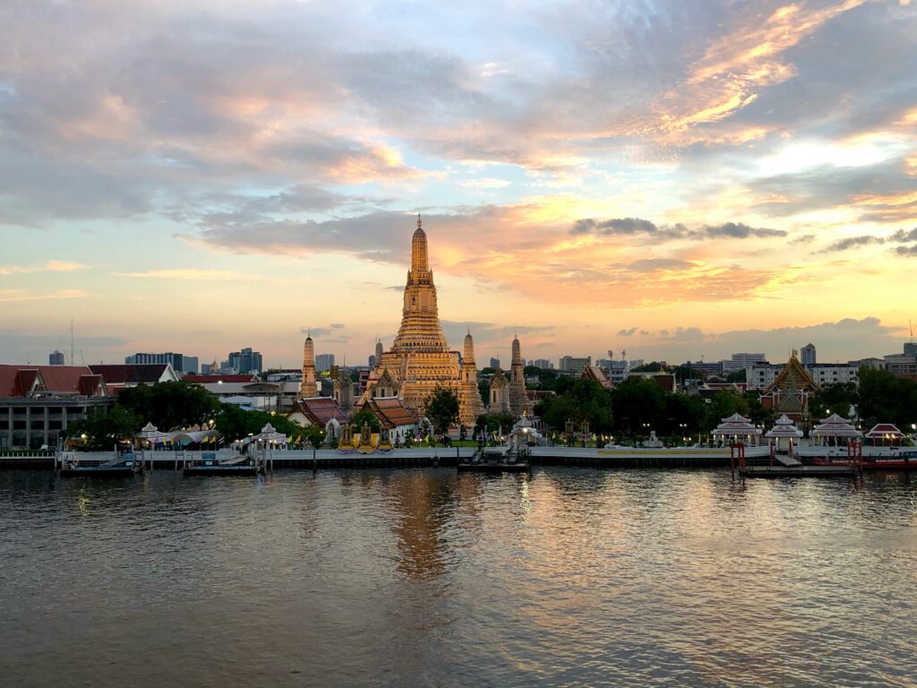 Wat Arun temple, "The Temple of the Dawn", at dawn across the Chao Phraya river. Probably Bangkok's most recognisable landmark. 