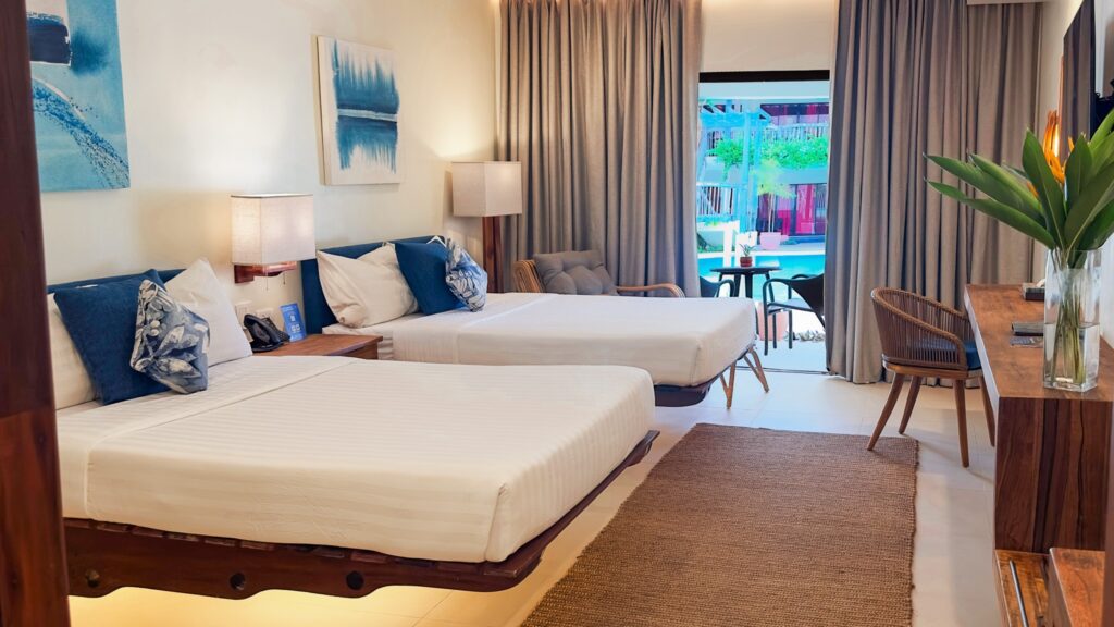 Bluewater Panglao Beach Resort, room with wall art and patio