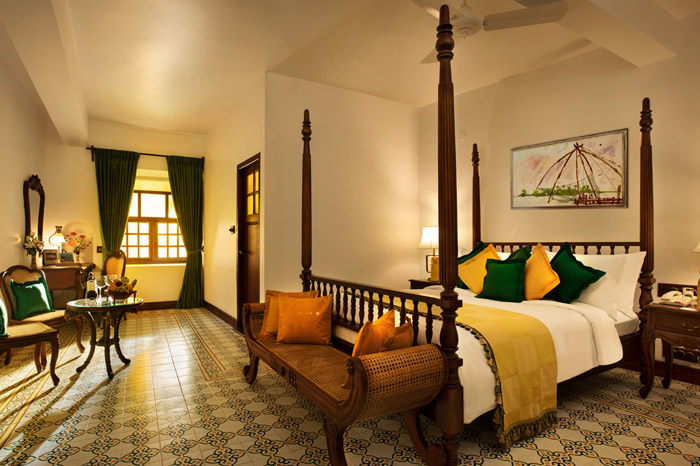 Where To Stay For a Soft Landing In India 20 Forte Kochi, room with patterned tiles and four-poster bed