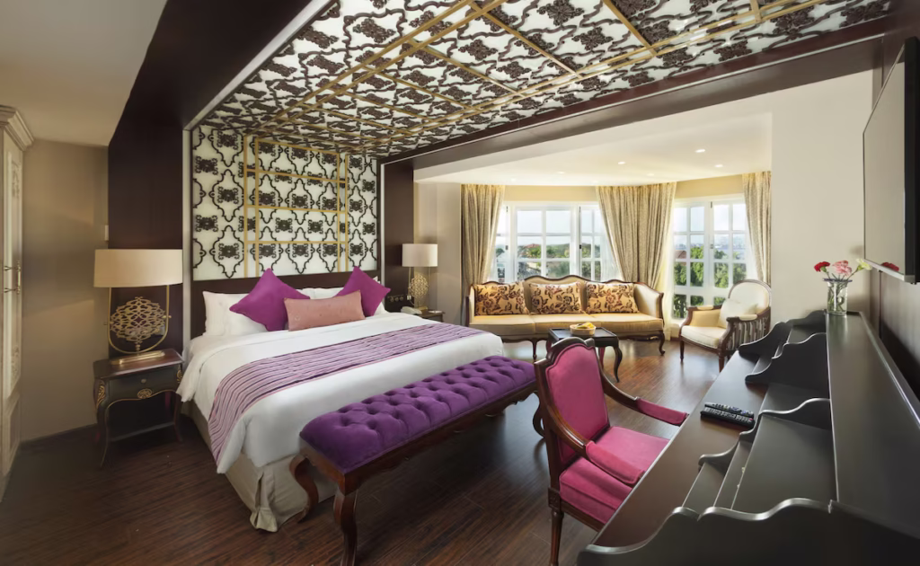 Where To Stay For a Soft Landing In India 19 Fragrant Nature Kochi, room with decorative patterned ceiling and dark wood furnishings