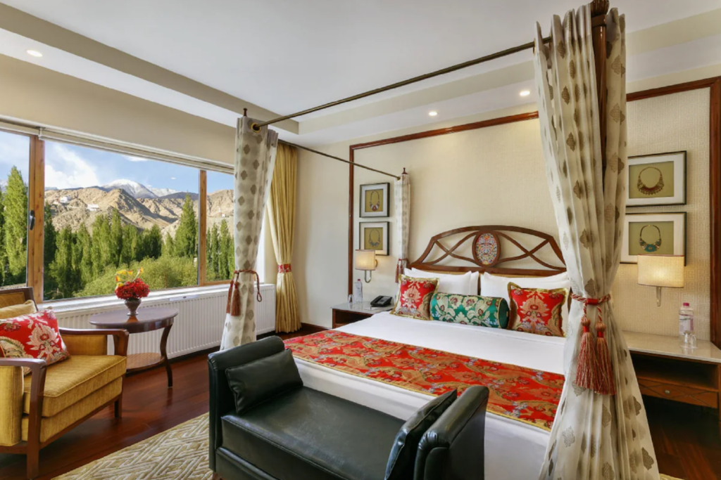 Where To Stay For a Soft Landing In India 38 The Grand Dragon Ladakh, room with a canopy bed and mountain views
