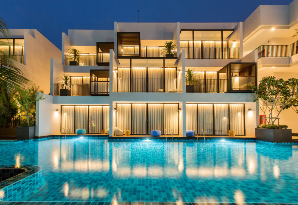 Asira Boutique Hua Hin hotel with illuminated pool at night