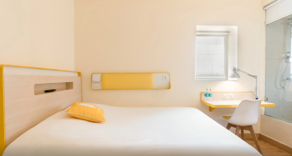 Where To Stay For a Soft Landing In India 4 bloomrooms Delhi, room with yellow accents and work desk