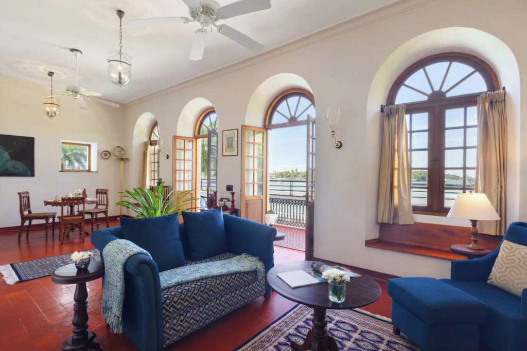 Where To Stay For a Soft Landing In India 18 Brunton Boatyard (Fort Kochi), living room with arched doors and windows, and a balcony overlooking the water