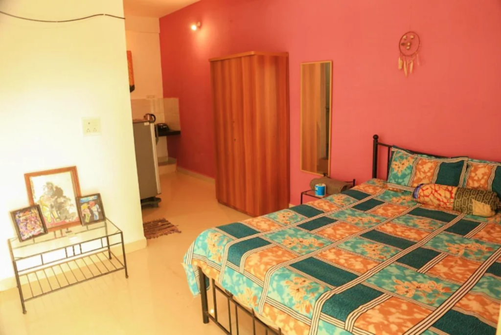 Where To Stay For a Soft Landing In India 24 Dreamcatcher House & Hostel, room with well equipped kitchen and pink accent wall