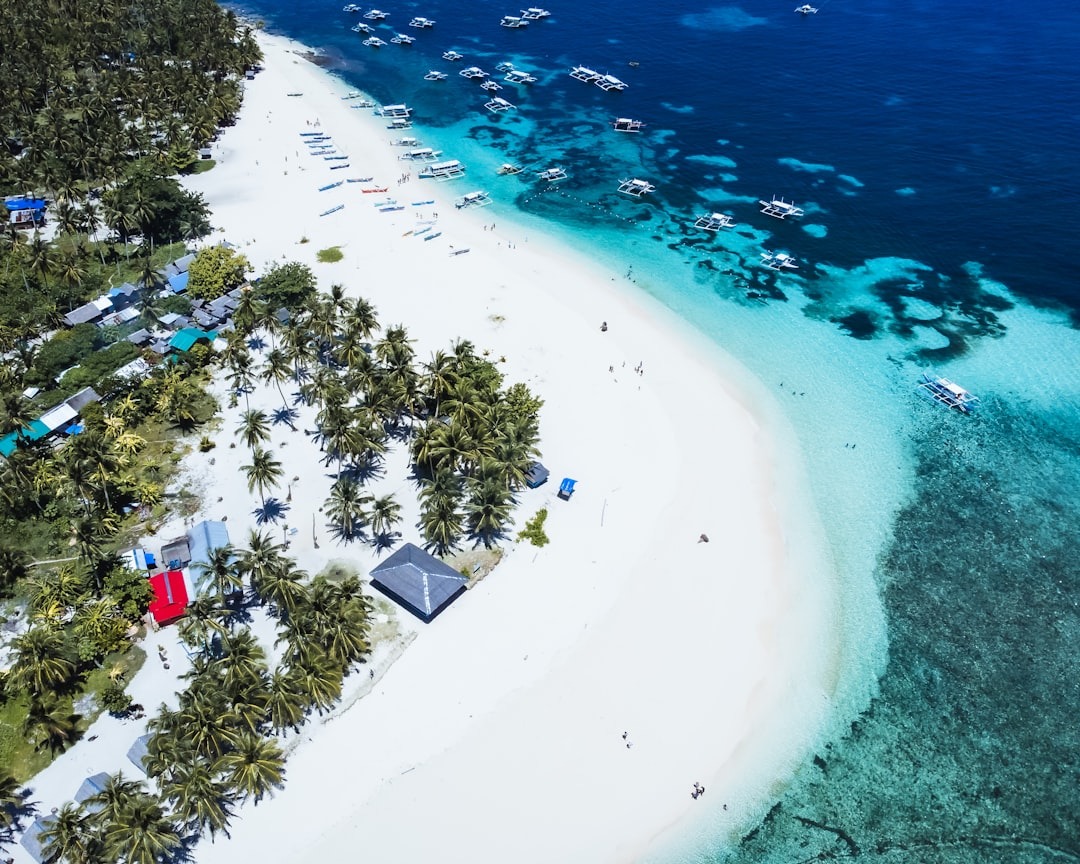 Aerial view of Daku Island in Siargao with white sand beach and turquoise waters