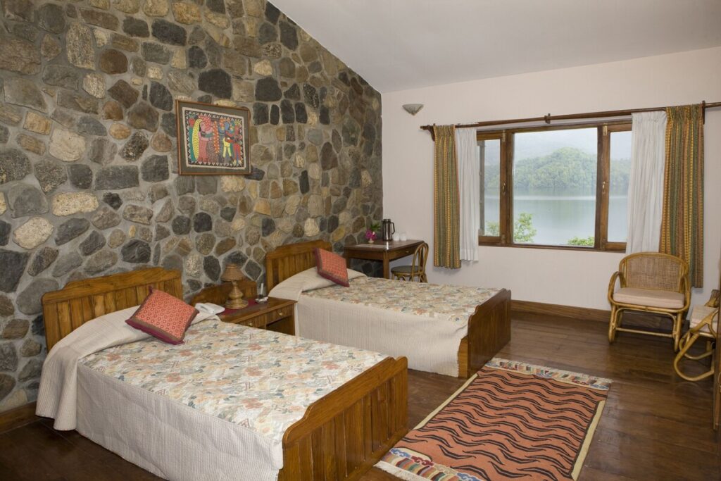 Begnas Lake Resort & Villas, Comfortable Room With Stone Accent Wall, Wood Touches, And Lake Views