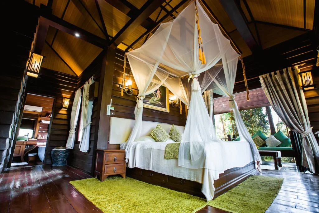 Jirung Health Village, room with canopy bed and dark wood accents