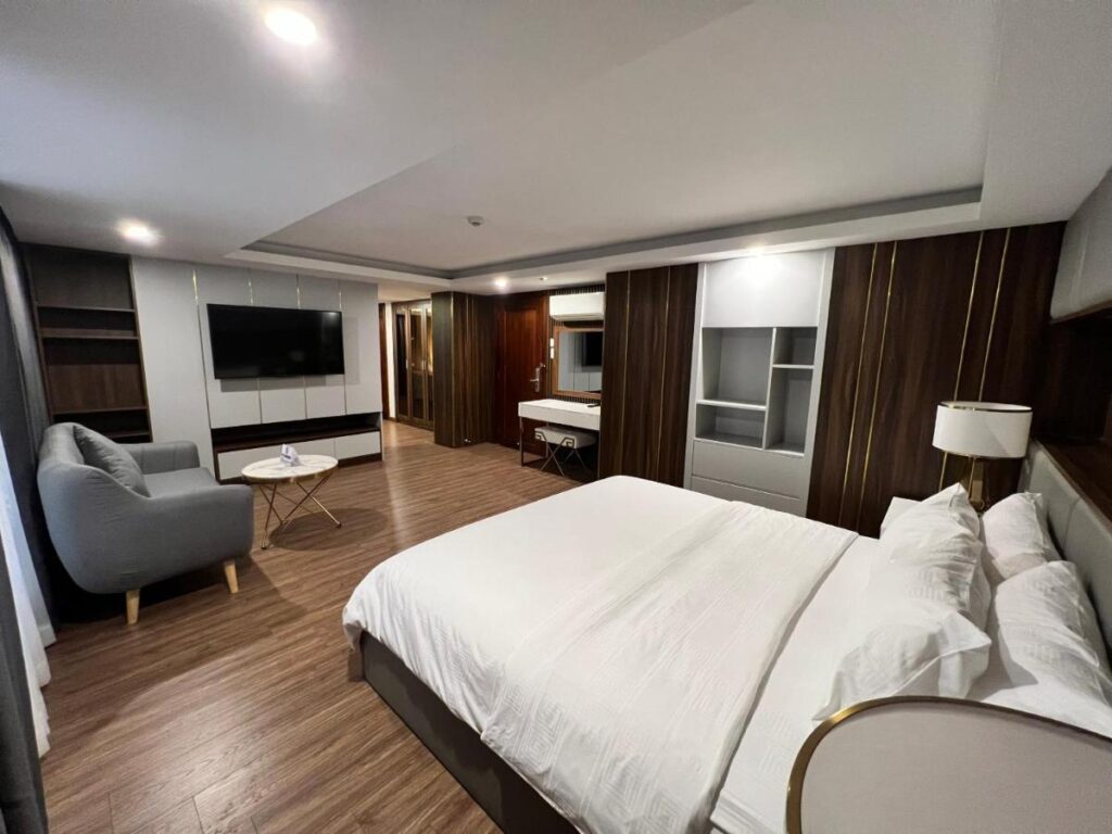 Nam Hy 1 Hotel, room with a seating area and wooden flooring