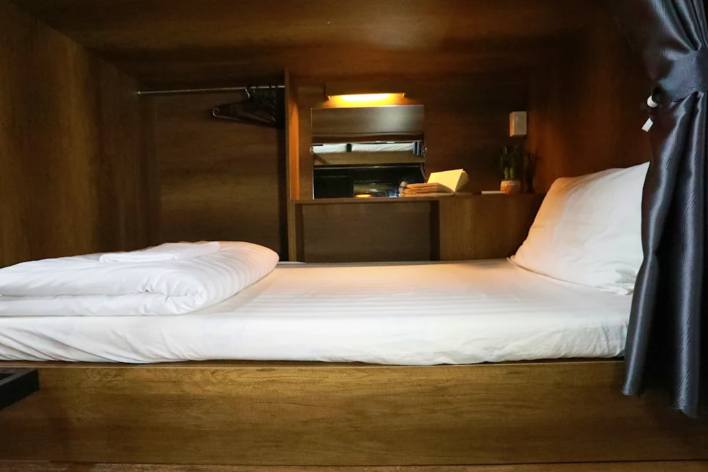 Saigon Chill Hostel, wooden bunk with privacy curtain