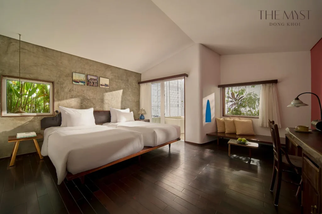 The Myst Dong Khoi, room with natural light, cozy reading corner, and work desk